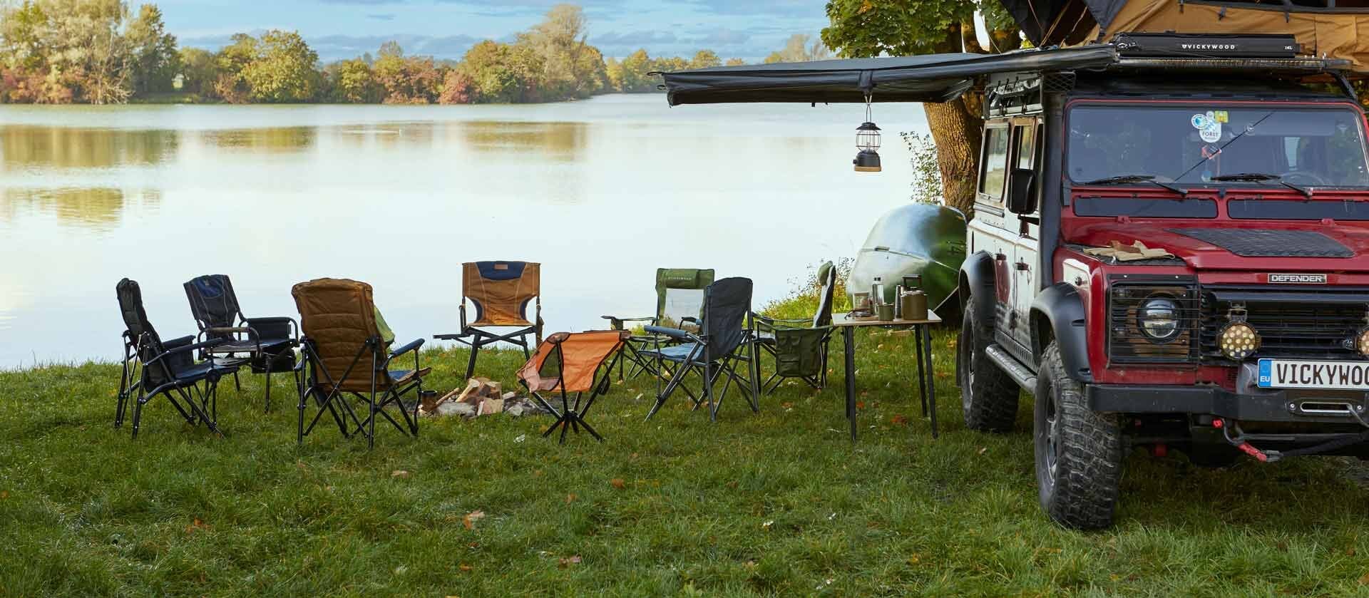 Campingstühle um eine Feuerstelle im Camp