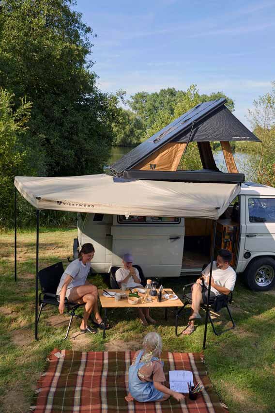 A family enjoys their campingtrip, while sitting together under their 270° Awning by VICKYWOOD.